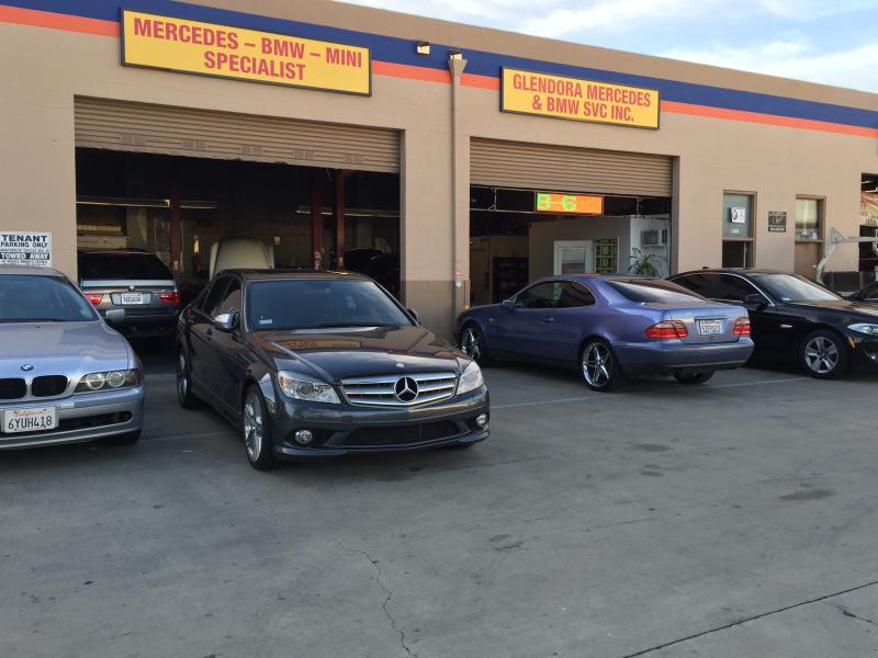 The Glendora Mercedes and BMW shop front in Covina with Mercedes-Benz and BMW cars parked at the open bays.