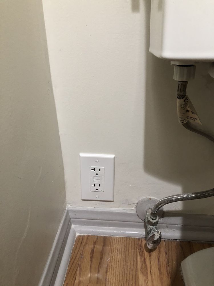 GFCI receptacle installed beside a bathroom water line.