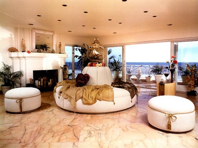Custom round settee with matching ottomans in a client living room.